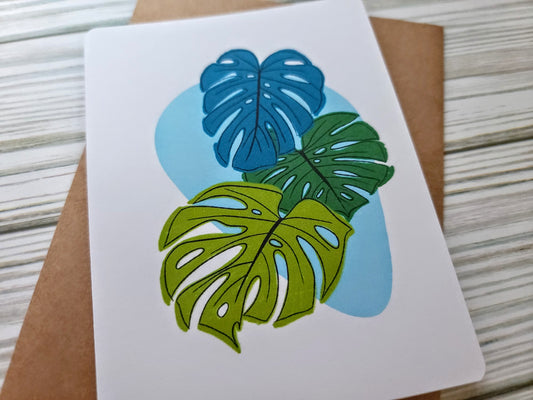 Monstera Leaves Handmade Greeting Card - Recycled Paper and Kraft Envelope - Angled Overhead Shot