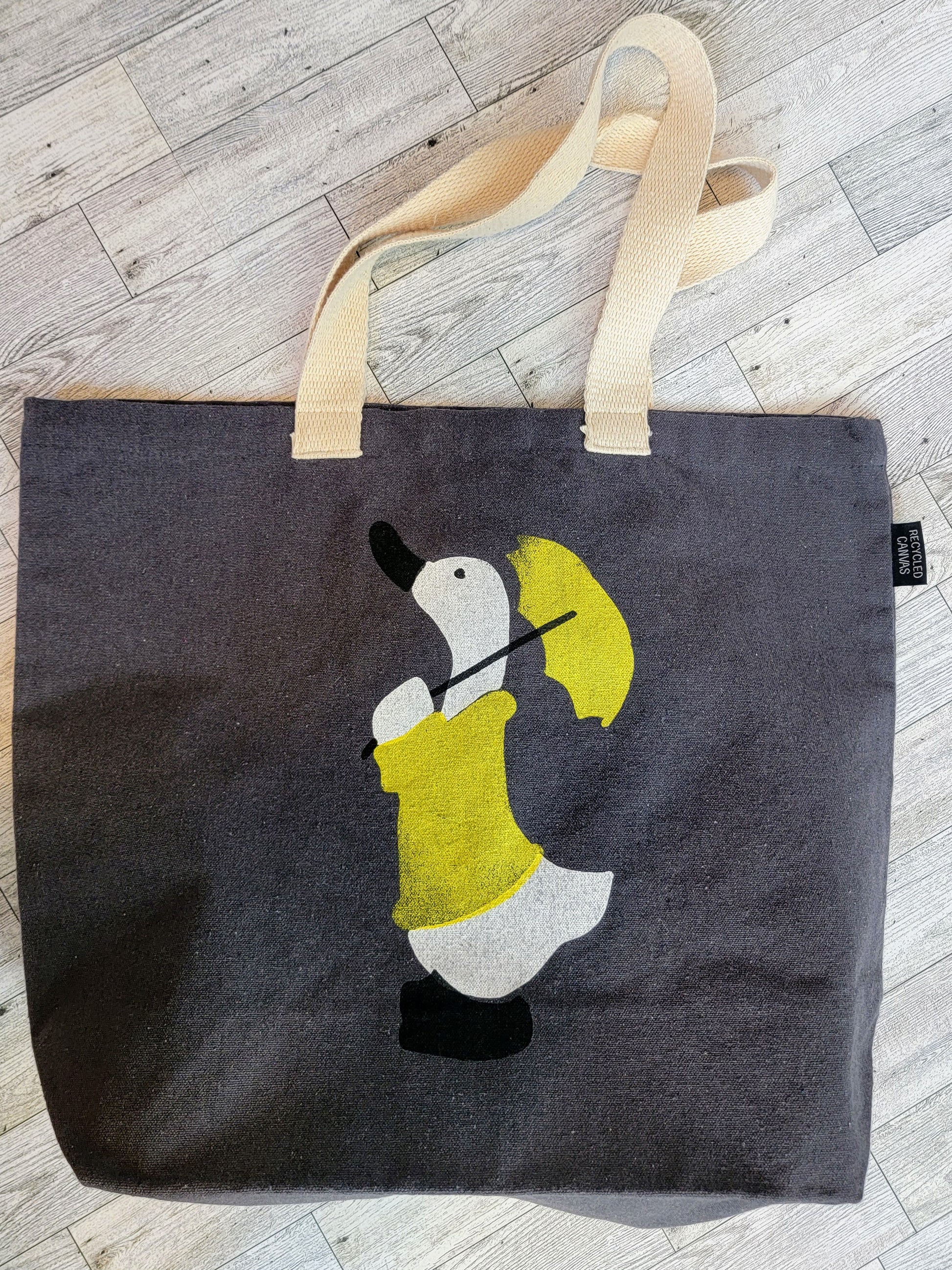 Duck in a Yellow Raincoat with matching Umbrella Dark Grey Recycled Canvas Tote Bag - Above Shot