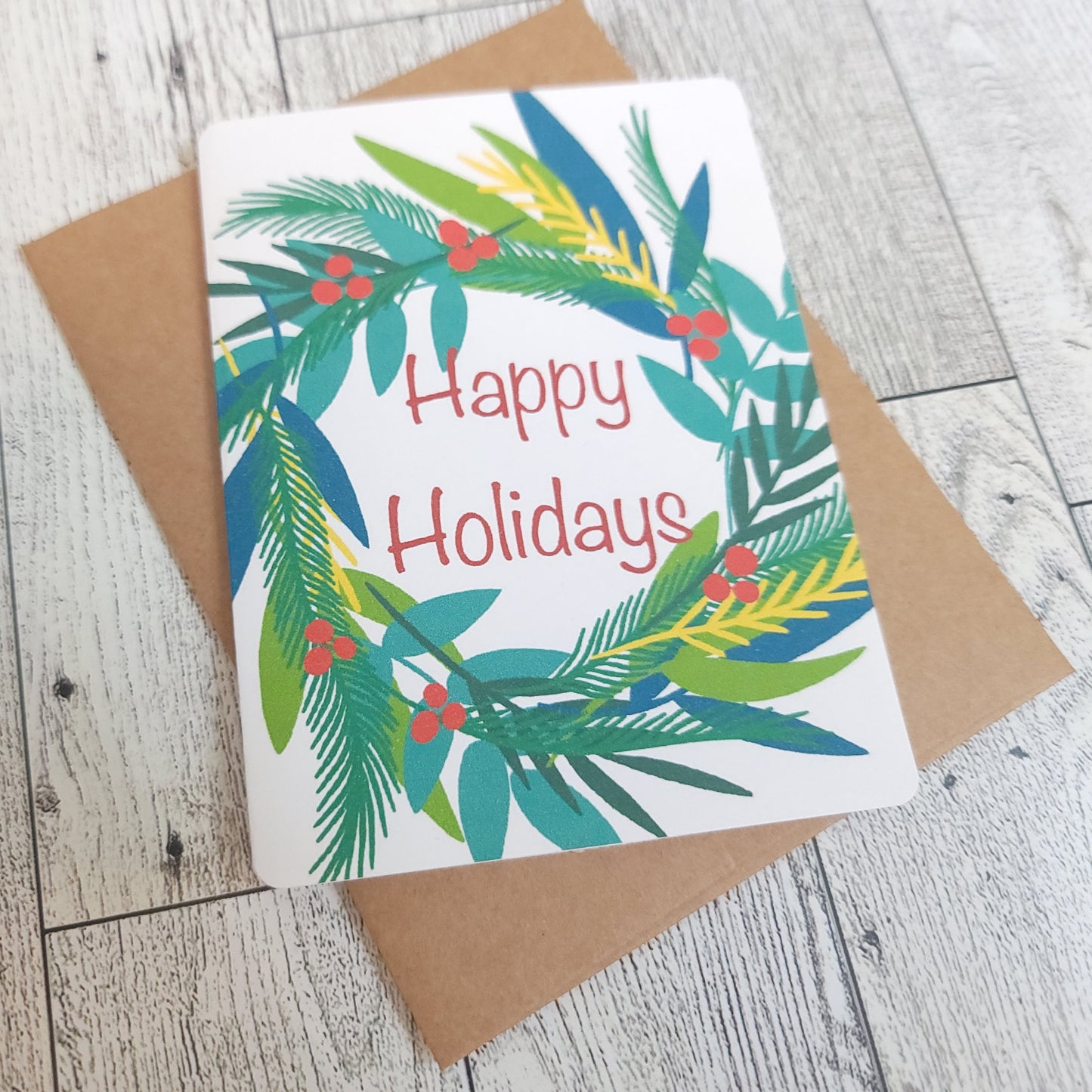 Happy Holidays Wreath Handmade Greeting Card - Recycled Paper and Kraft Envelop - Angled Overhead Shot